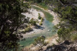 Curving Paluxy River as seen from above in Dinosaur Valley State Park, home to some of the best camping near dallas texas