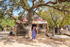 Kate Storm in front of the former post office of luckenbach texas, one of the best things to see in luckenbach