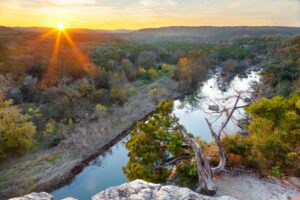 sun setting over barton creek greenbelt, one of the best places to go hiking in austin texas