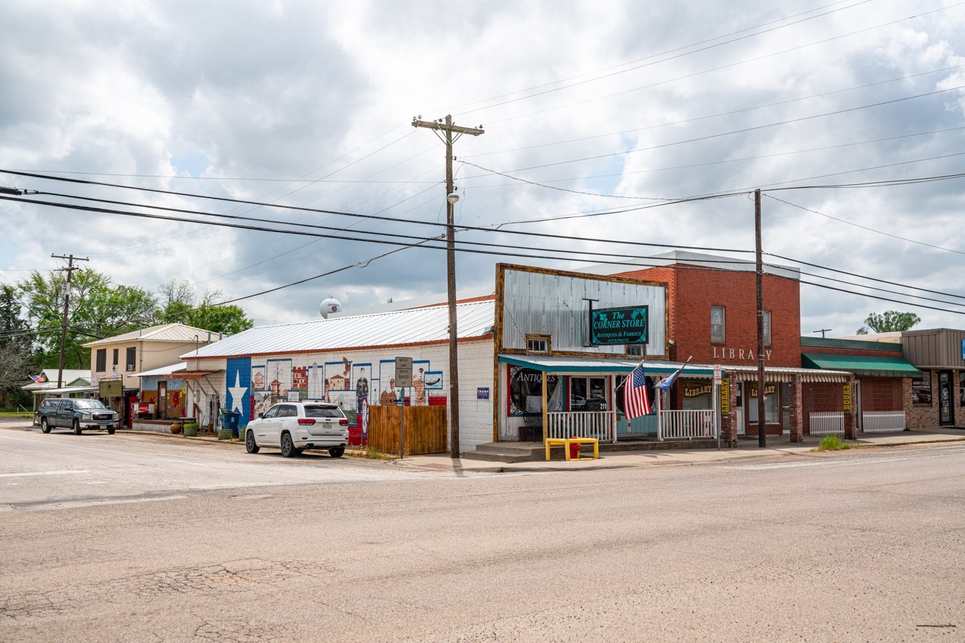 shops in downtown centerville texas with a mural visible on one side