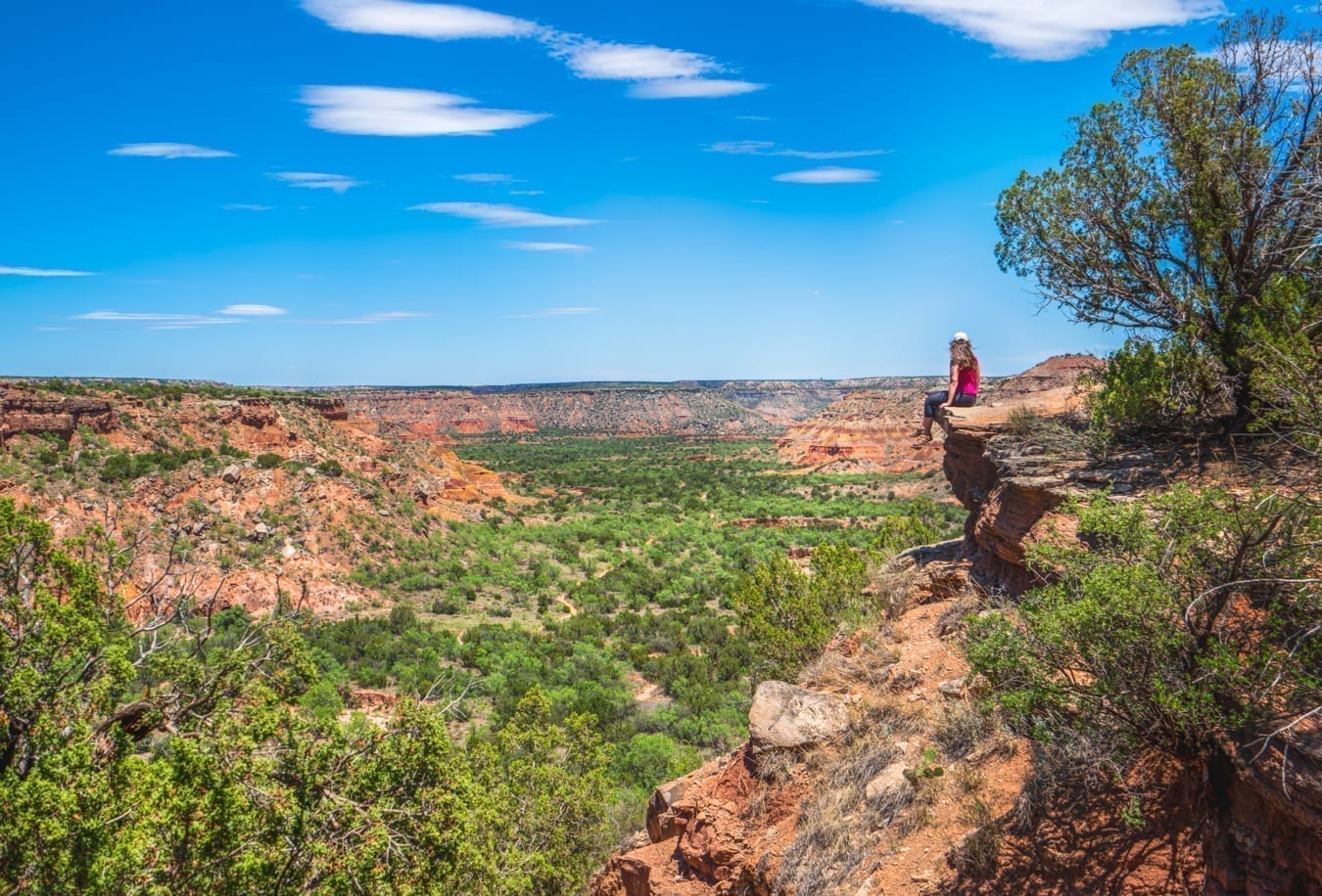 Kate Storm sitting on a ledge overlooking palo duro canyon near amarillo texas