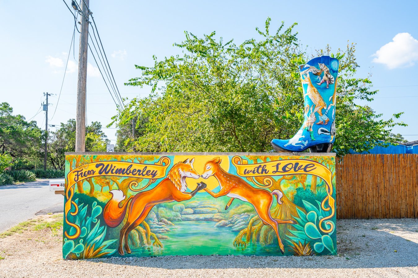 mural of two colorful foxes in wimberley texas with a painted boot on top--tracking down the painted boots is one of the fun things to do in wimberley tx