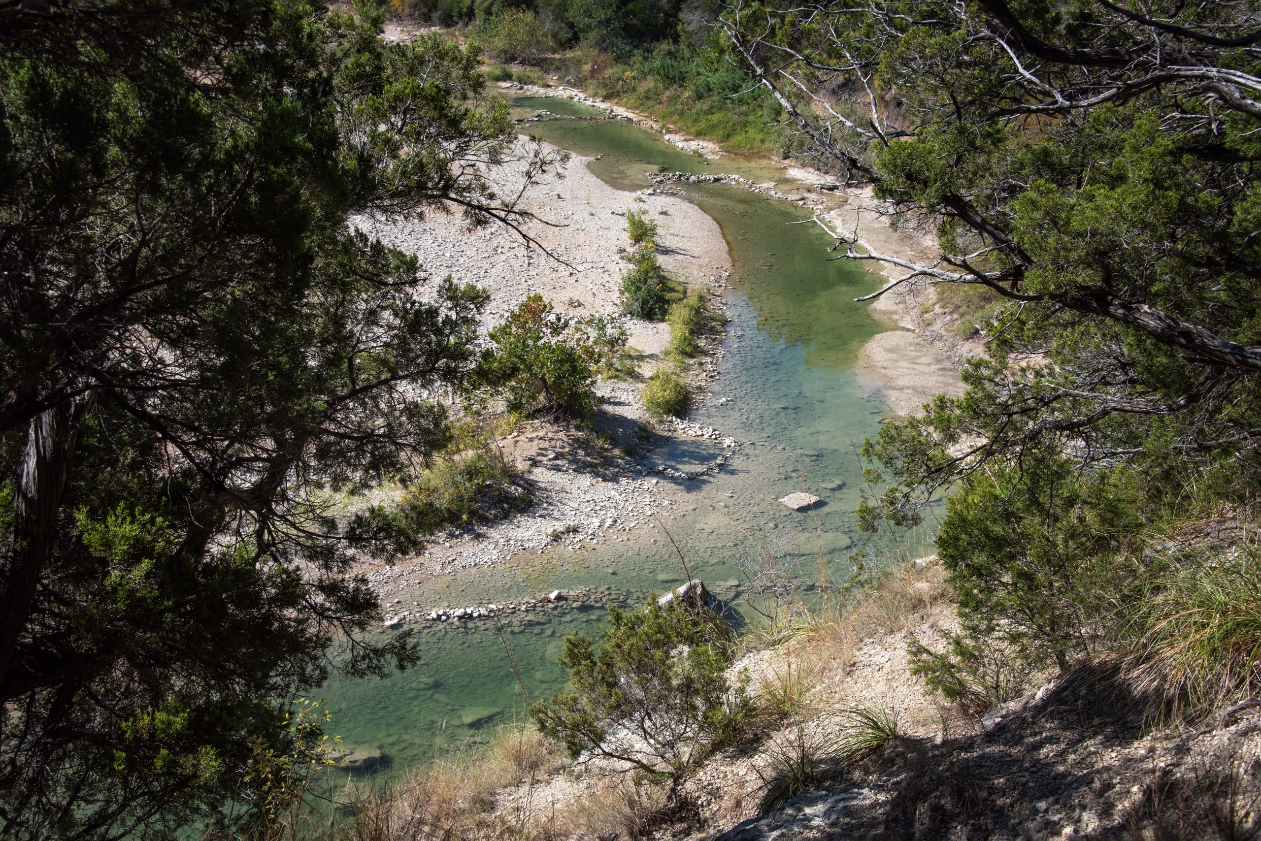 Curving Paluxy River as seen from above in Dinosaur Valley State Park, home to some of the best camping near dallas texas