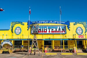 Yellow building of Big Texan State Ranch shot from the front, one of the best texas route 66 attractions