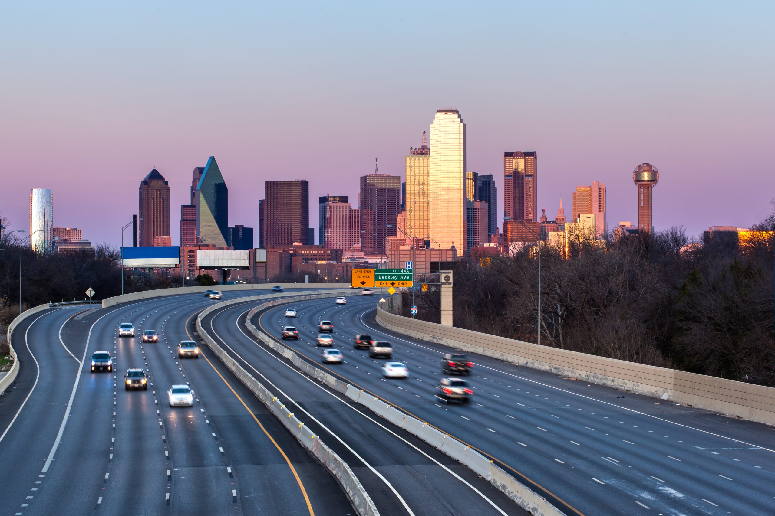 freeway in dallas texas with the skyline in the background. large interstate views like this are common when driving from dallas to san antonio texas