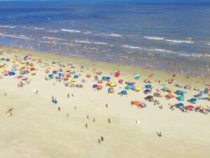 aerial view of colorful umbrellas and crowds in galveston, home to some of the best beaches in texas