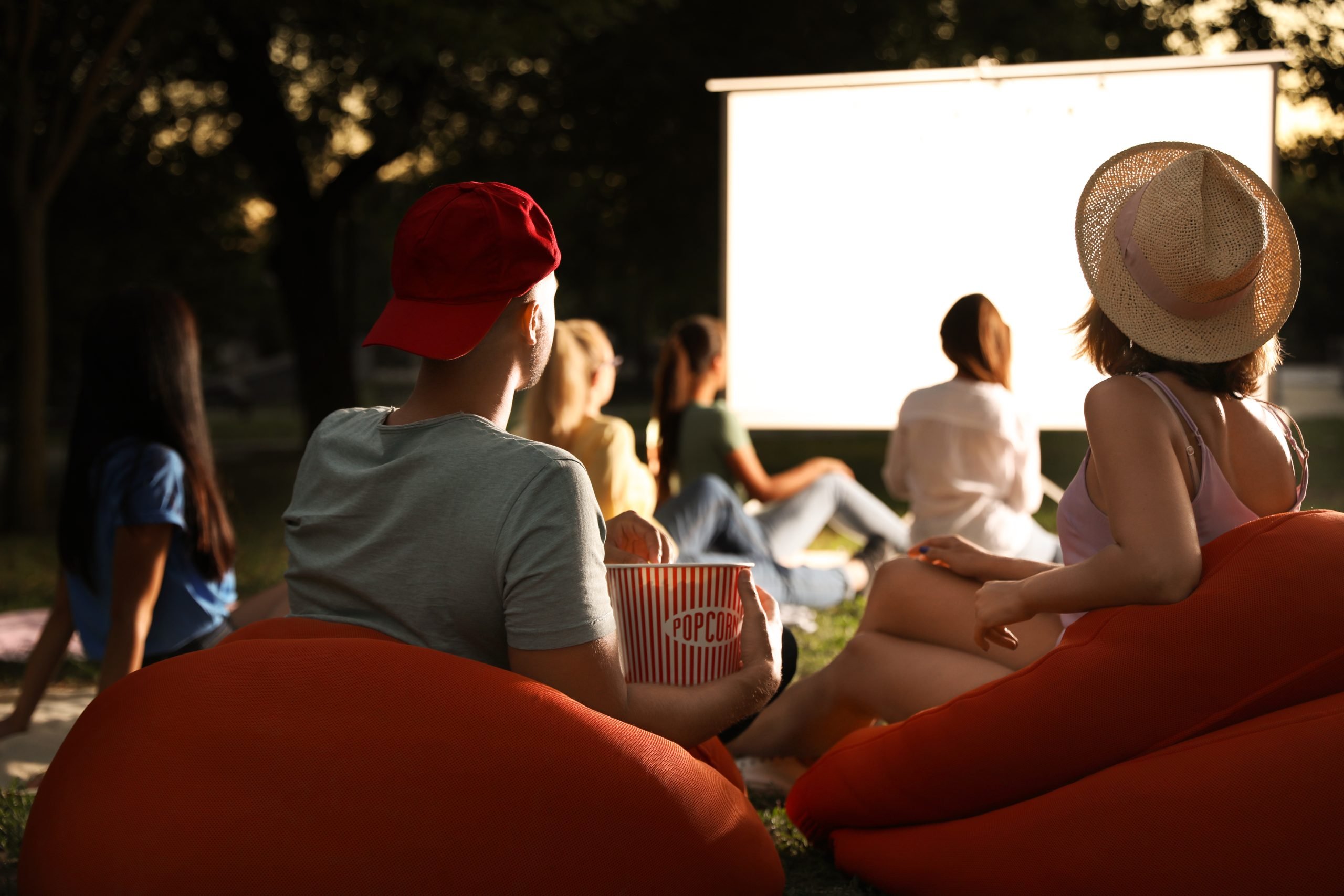 group of people assembled to watch one of the movies set in texas on a projection screen