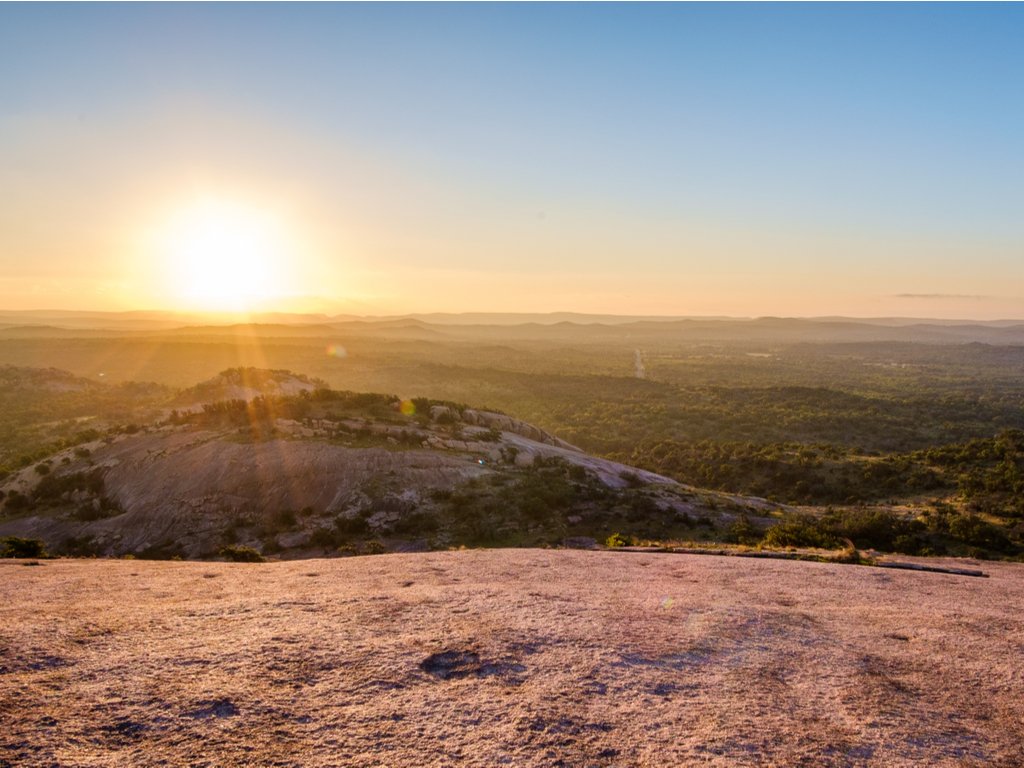 sunrise over enchanted rock texas as viewed after completing the summit trail enchanted rock hike