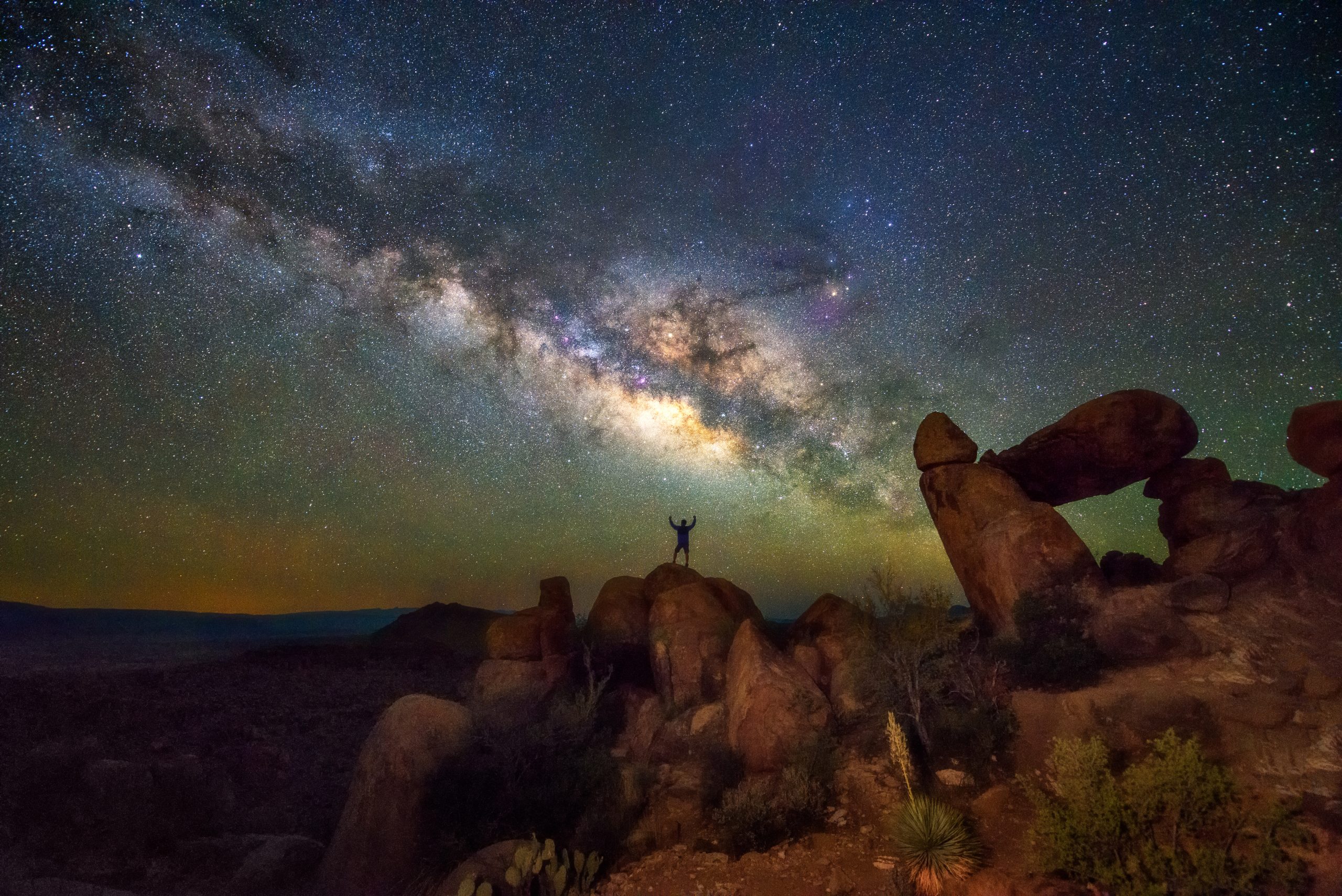 hiker standing under milky way in big bend national park, one of the best things to do in west texas