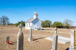 smallest catholic church in the world in warrenton texas exterior with cemetery in the foreground