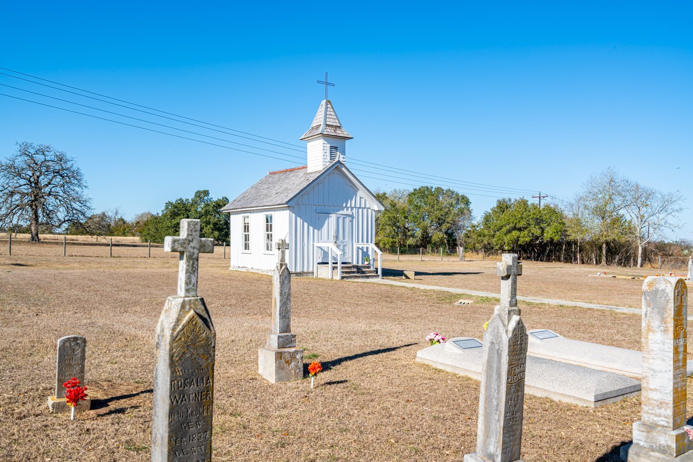 smallest catholic church in the world in warrenton texas exterior with cemetery in the foreground