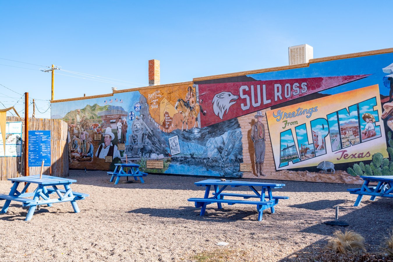 mural of sul ross flag and greetings from alpine postcard in food truck park, one of the best things to do in alpine tx