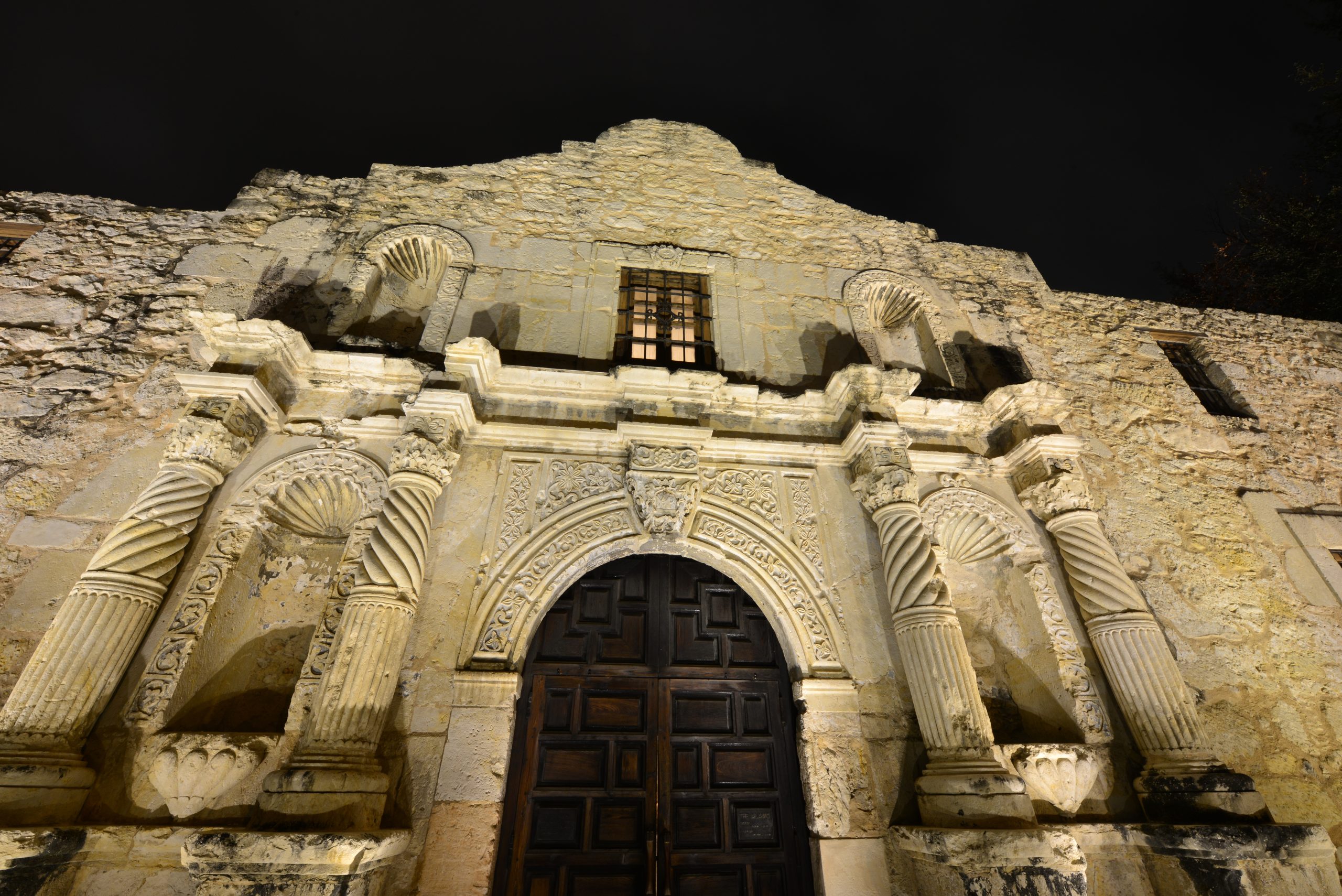 front facade of the alamo at night, one of the most haunted places in san antonio paranormal activity