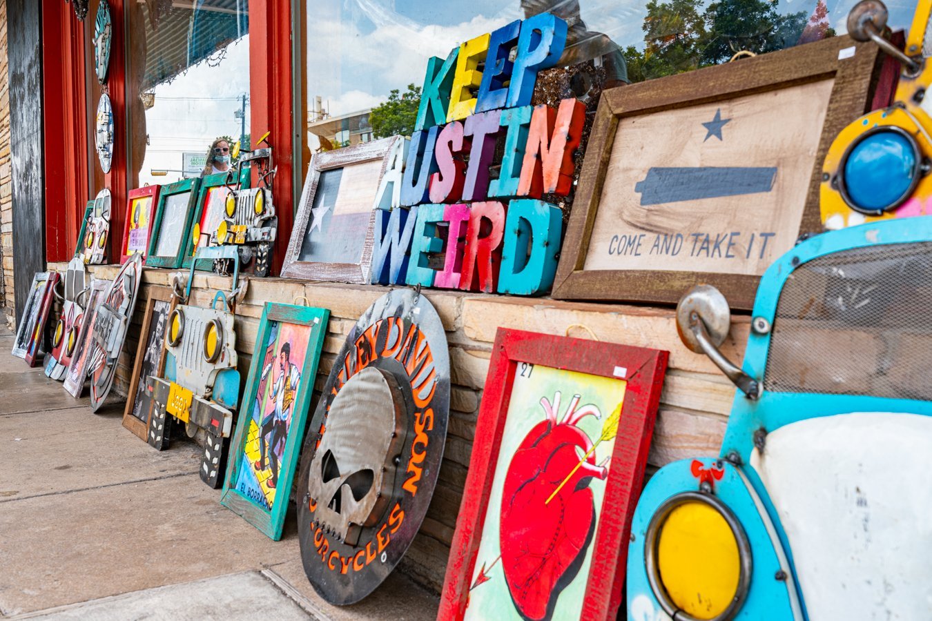 collection of art for sale on south congress, including a keep austin weird sign, one of the best quotes about austin texas